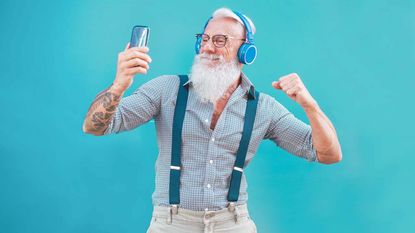 Man with white beard wearing headphones