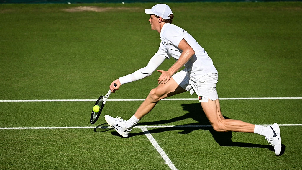 Jannik Sinner plays a forehand during his Wimbledon 2025 semifinal against Novak Djokovic