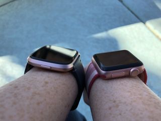 Fitbit Versa (left) and Apple Watch Series 1 (right)