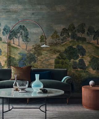 Living room with large woodland mural and green velvet couch