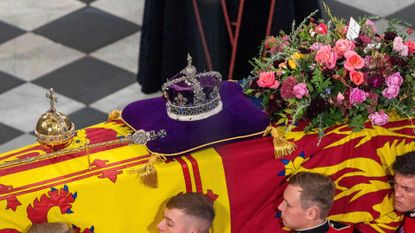 Queen Elizabeth II's coffin, draped in the Royal Standard with the Imperial State Crown, the Sovereign’s Orb and the Sceptre placed on top of it 