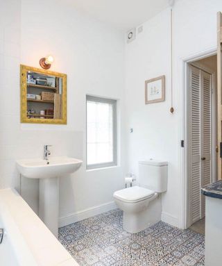 white bathroom with yellow mirror