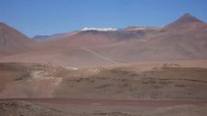 A snow-topped volcano in the desert