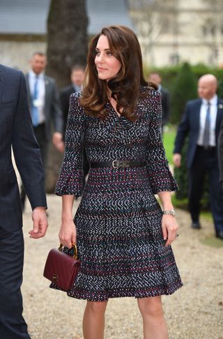 Kate Middleton wearing Chanel logo belt with Chanel dress and Chanel bag in Paris 2017 - Kate Middleton loud luxury accessory