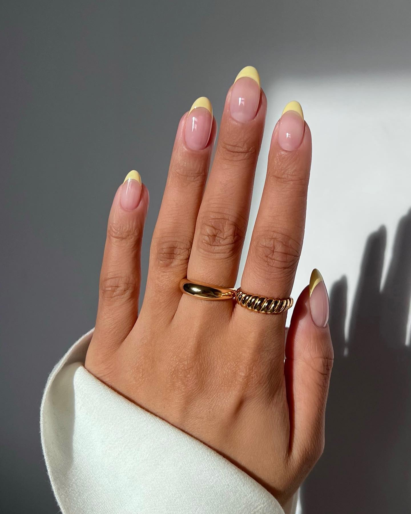 Oval nails with pastel yellow French tips