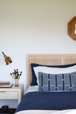 white bedroom with rattan headboard