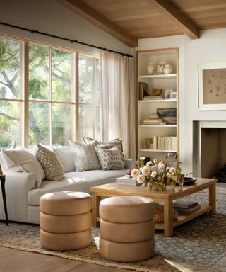 farmhouse style living room with wood paneled ceiling a large white couch and wooden coffee table