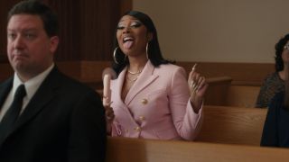 Megan Thee Stallion sitting in a courtroom fanning herself in She-Hulk.