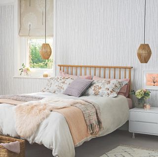 Bedroom with grey wallpaper, hanging pendant lights and wooden bedframe