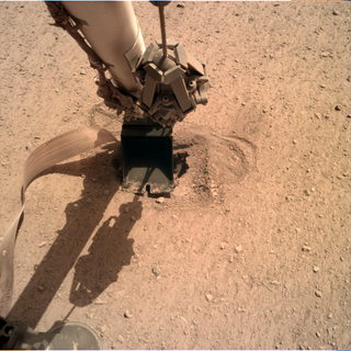 An image taken on June 3, 2020, shows the arm of the InSight lander gently pushing the heat probe into Mars.