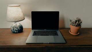 A black screen on MacBook Pro on a desk