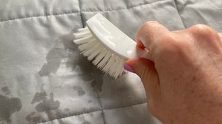 Use a soft brush to spot clean a weighted blanket