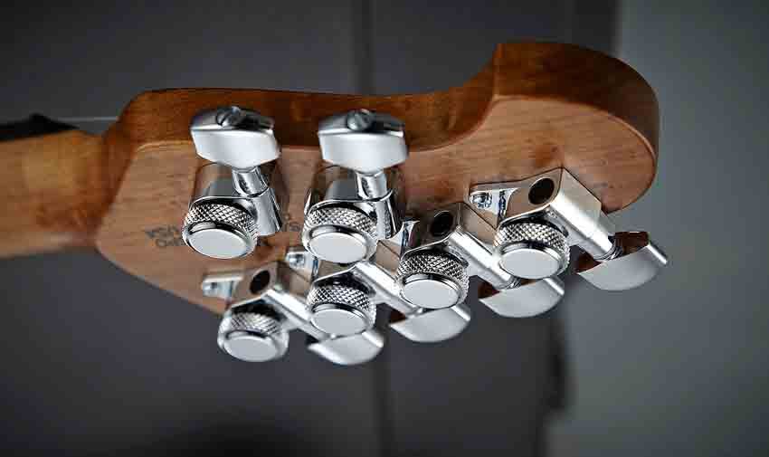 The guitar features Music Man's familiar compact 'four-and-two' headstock