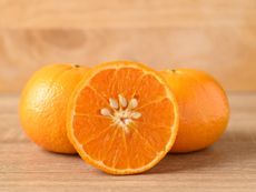 Whole And Sliced Open Orange Fruit With Seeds