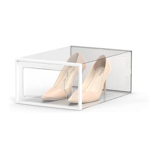 Plastic shoe storage box holding high heels against white background