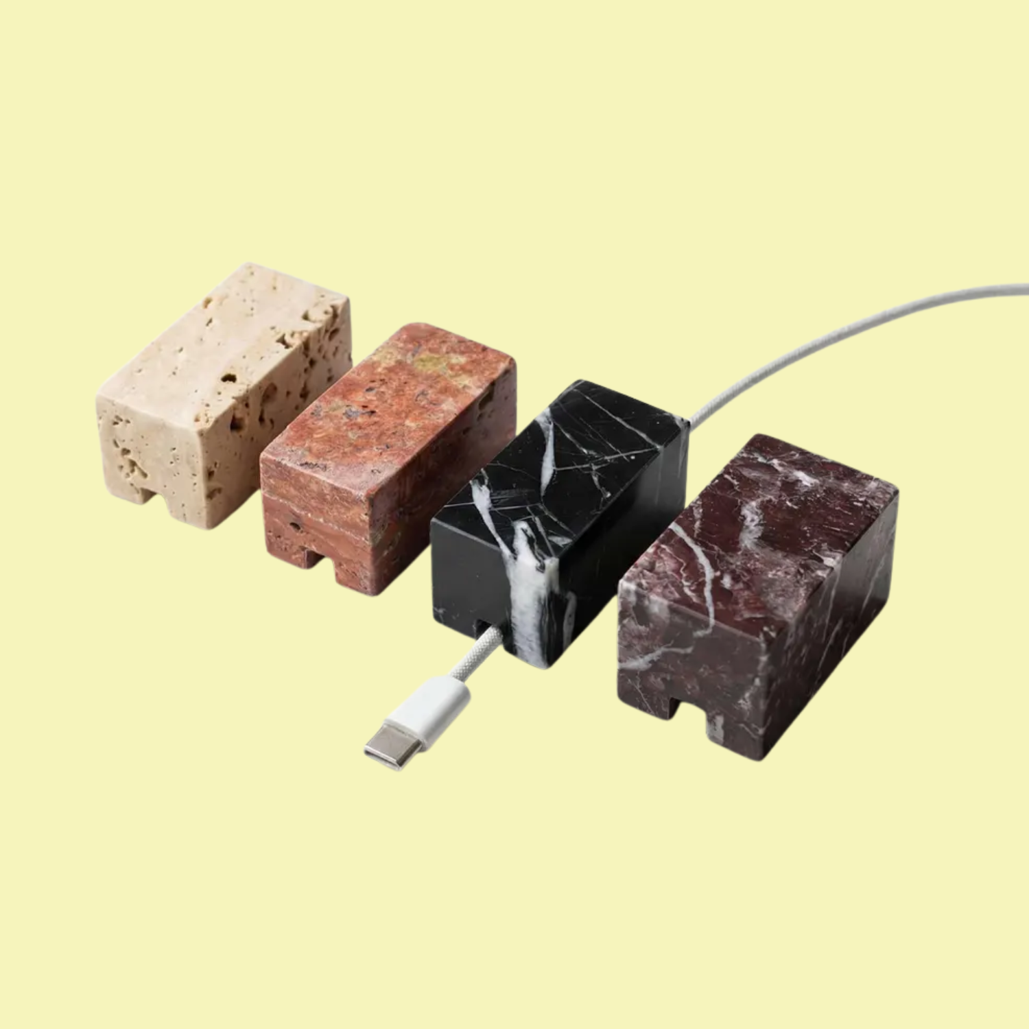 A set of four marble cable holders