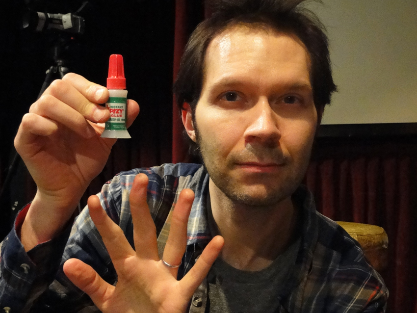 Serious business: Pre-soundcheck, Gilbert prepares to apply Krazy Glue to a sliced-open finger
