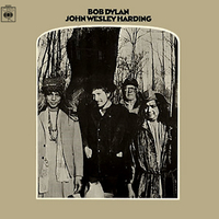 John Wesley Harding (Columbia, 1968)
The comeback album after the 18-month hiatus that followed his motorcycle accident, John Wesley Harding represented a new watershed in Dylan’s recording career. While musically it marked a return to his acoustic roots, its lyrics had a new, quasi-religious flavour that baffled as many as it entranced. 
Its cover also pictured Dylan in new, sober mode, sporting plain ‘country clothes’, as opposed to the dishevelled, Chaplin-esque figure of before. In keeping with this new austere image, no singles were from the album were released, although an electrifying (in the literal as well as metaphorical sense) cover of All Along The Watchtower was later a huge hit for Jimi Hendrix. 
