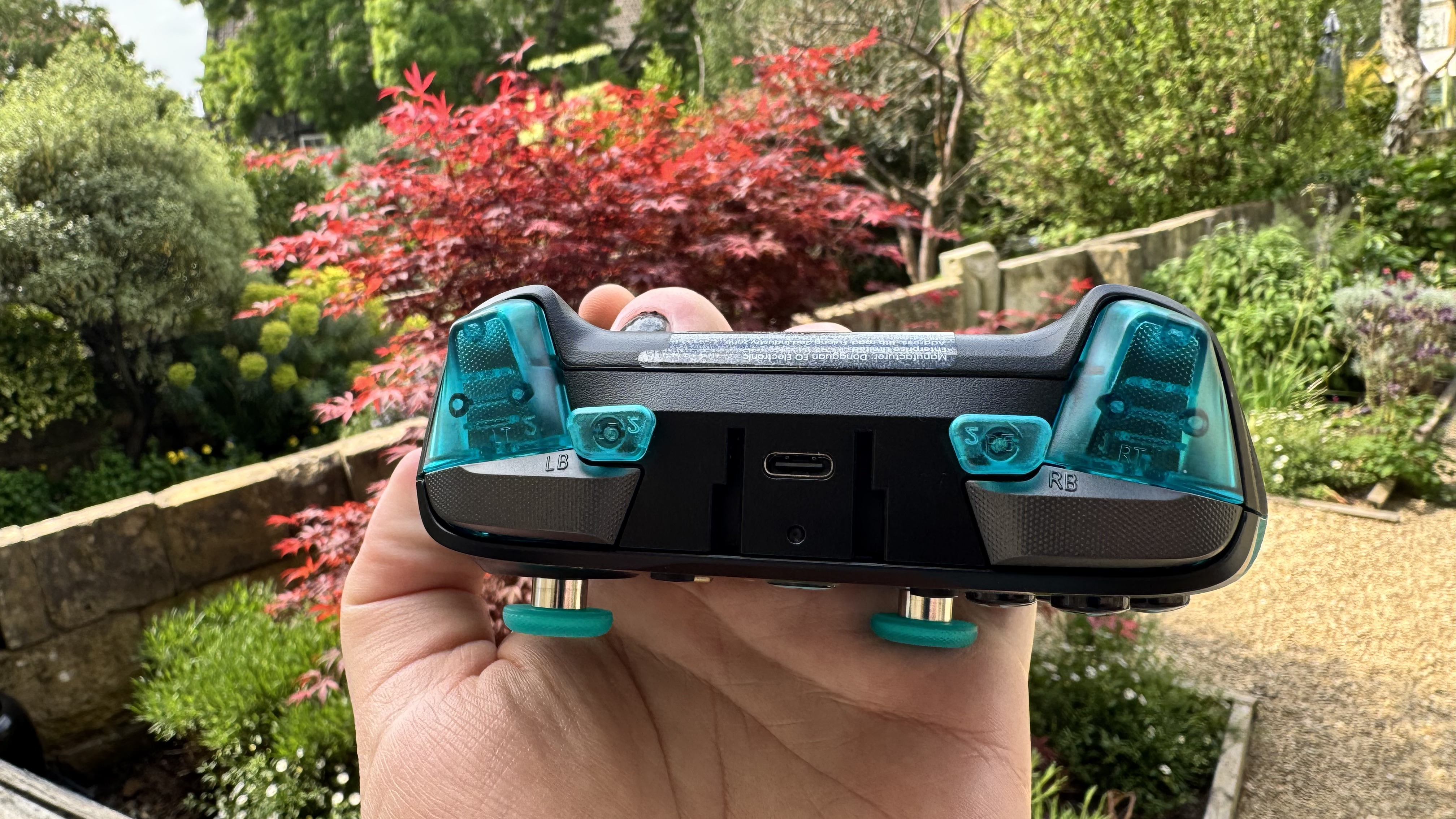 The GameSir G7 Pro 8K Aimlabs Edition from the top, in a hand, outside