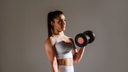 Woman performing dumbbell biceps curls