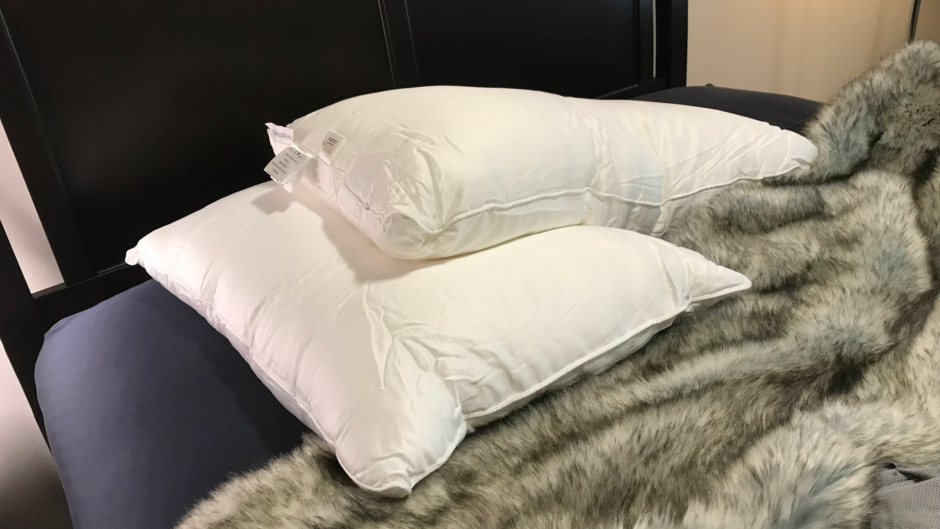 A pair of Cozy Earth Silk Pillows on a bed
