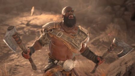 Diablo 4 Barbarian trailer screenshot shows a man wielding two axes shouting.
