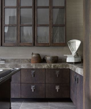 Grey kitchen with walnut cabinets and grey surface