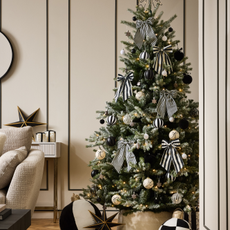 Next black and white stripe bows decorating a green christmas tree.