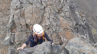 Woman rock climbing in Scotland