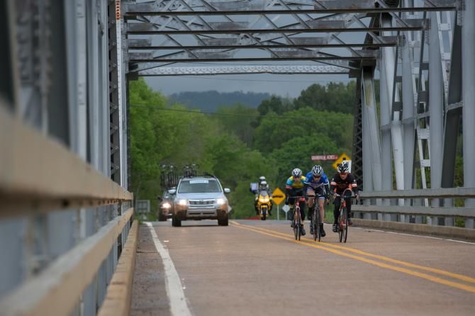 The breakaway crosses a bridge under threatening skies in Friday's road race.