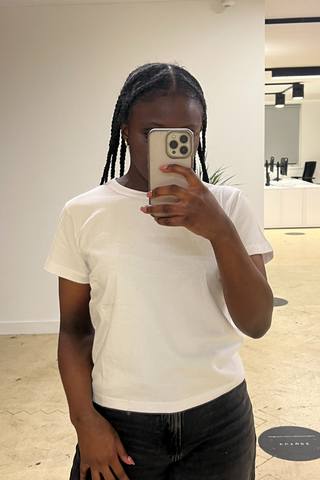 An image of Who What Wear UK editorial assistant, Brittany Davis, wearing one of the best white t-shirts.