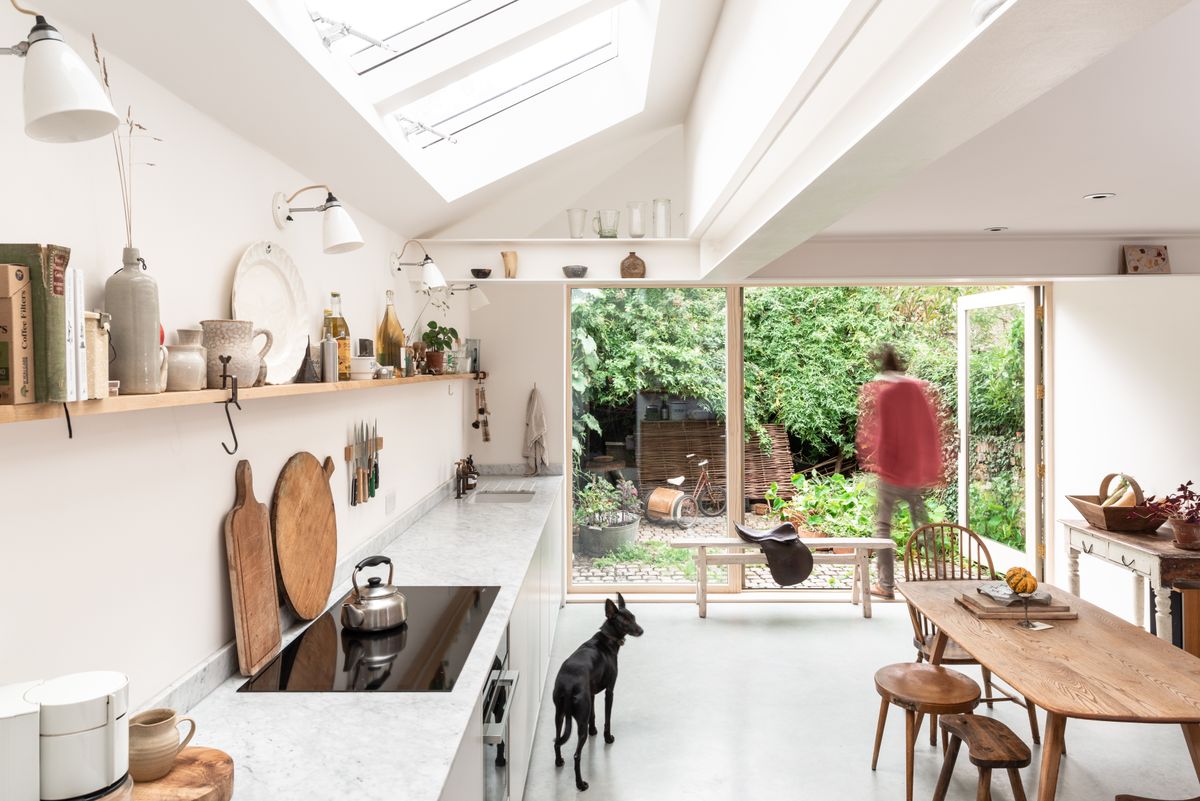 pale kitchen and dining extension with view to garden