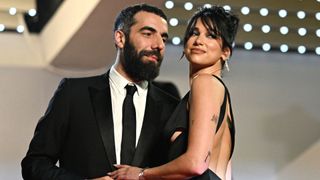 French director Romain Gavras (L) and British singer and model Dua Lipa arrive for the screening of the film "Omar la Fraise" (The King of Algiers) during the 76th edition of the Cannes Film Festival in Cannes, southern France, on May 20, 2023.