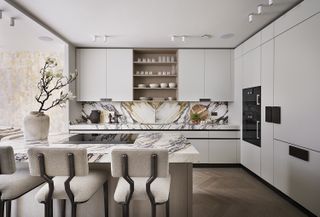 marble kitchen with white bar stools
