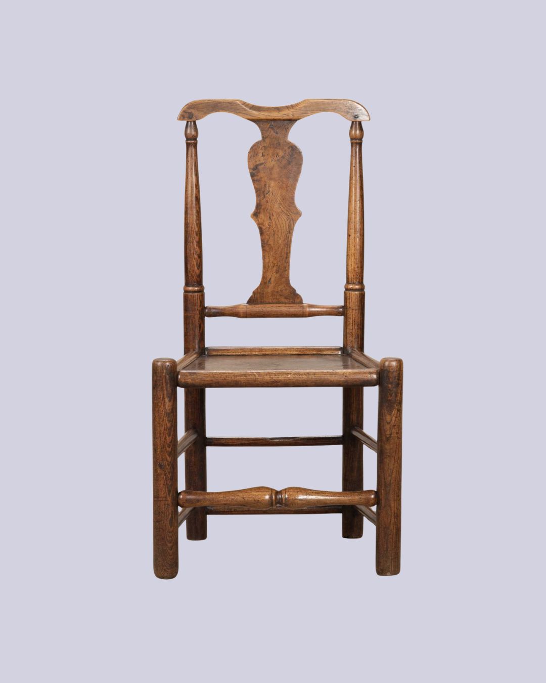 18th Century English Provincial Elm Chair against pale purple background.