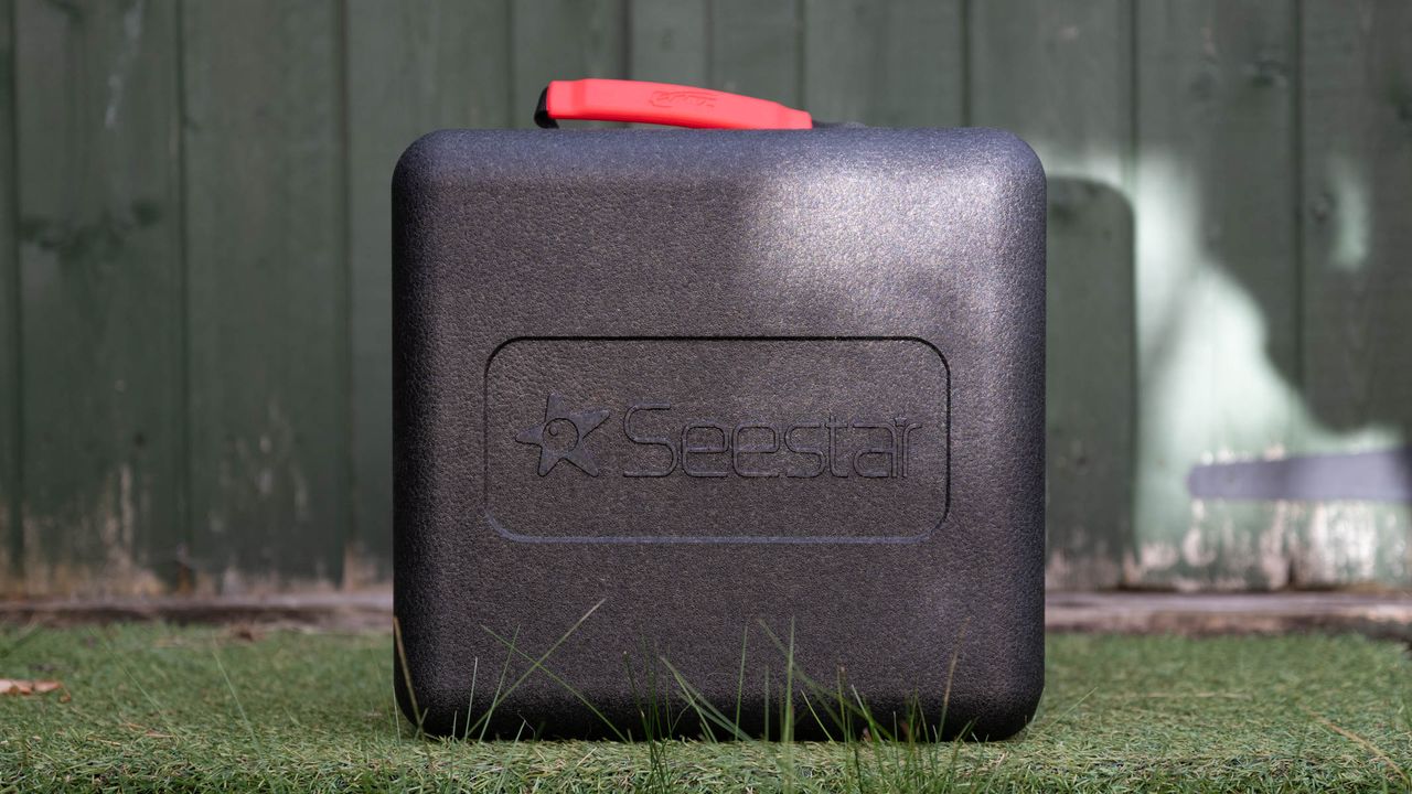 ZWO Seestar S50 Pro on a tripod against a green shed
