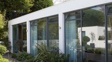 architectured building with glass door and garden 