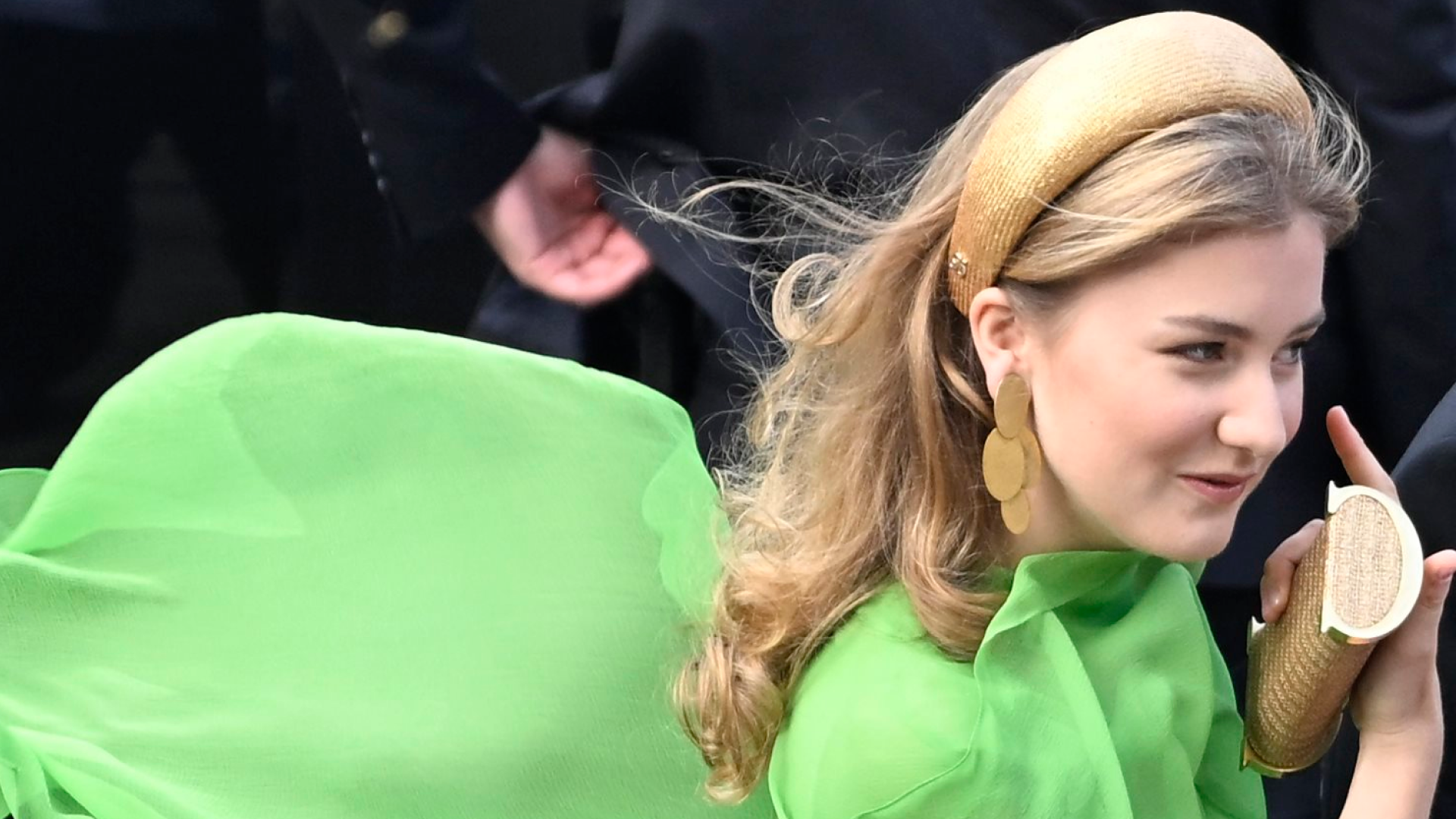 Princess Elisabeth of Belgium wearing a green caped dress flowing behind her