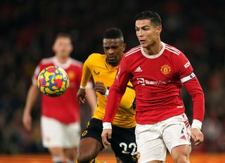 Wolverhampton Wanderers’ Nelson Semedo (left) and Manchester United’s Cristiano Ronaldo battle for the ball during the Premier League match at Old Trafford, Manchester. Picture date: Monday January 3, 2022