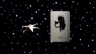 You can download an origami X-wing fighter from Moleskine's website