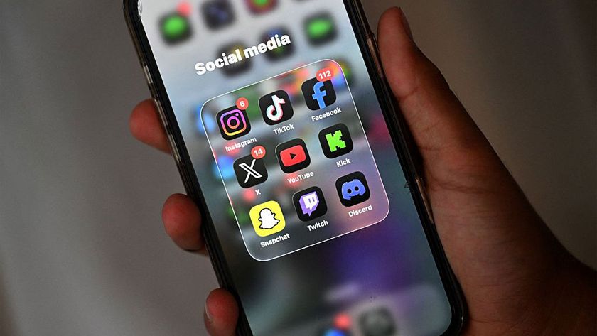 social media icons on a phone with a hand holding it
