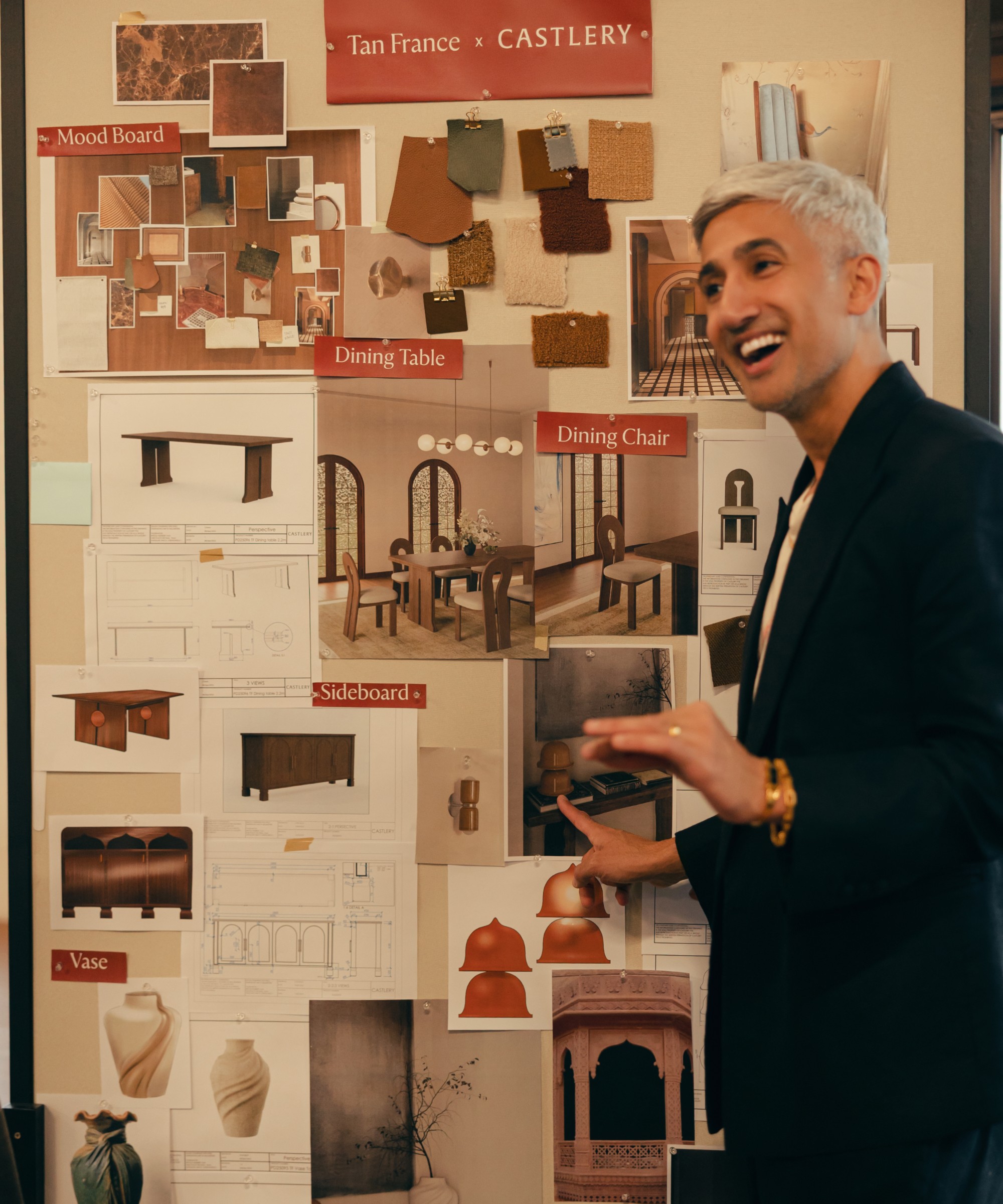 Tan France pointing at the mood board for his collection with Castlery