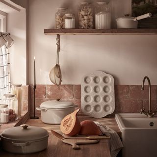 A rustic kitchen with Stacey Solomon's for George Home cookware and bakeware displayed