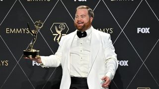 US actor Paul Walter Hauser poses in the press room with the Outstanding Supporting Actor in a Limited/Anthology Series or Movie award for "Black Bird" during the 75th Emmy Awards