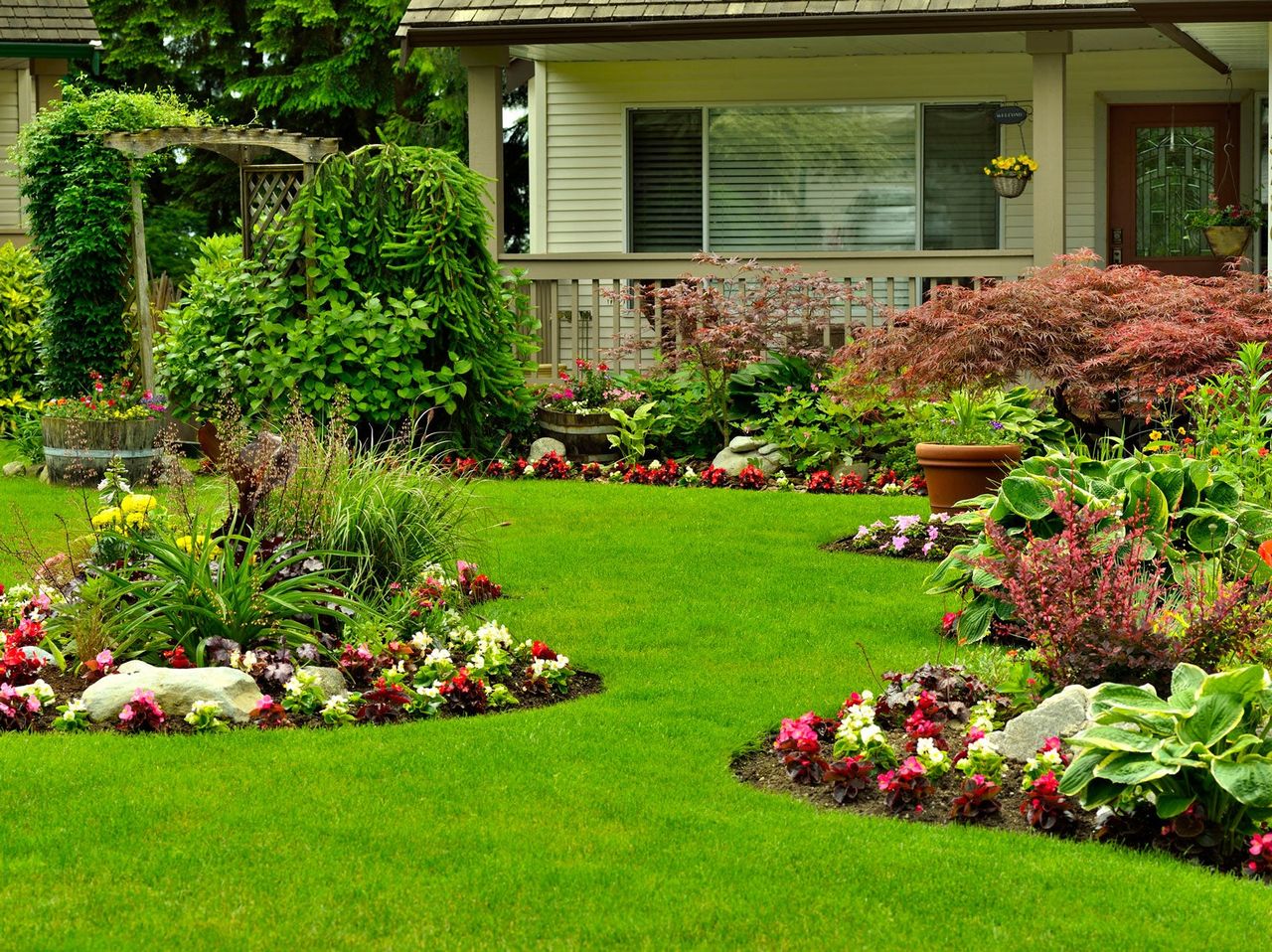 Front Yard With Garden Beds Full Of Plants And Flowers