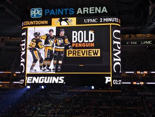The Pittsburgh Penguins centerhang display shines bright over the ice during a game.