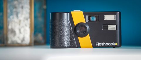 Lifestyle photo of the Flashback camera against a light blue background