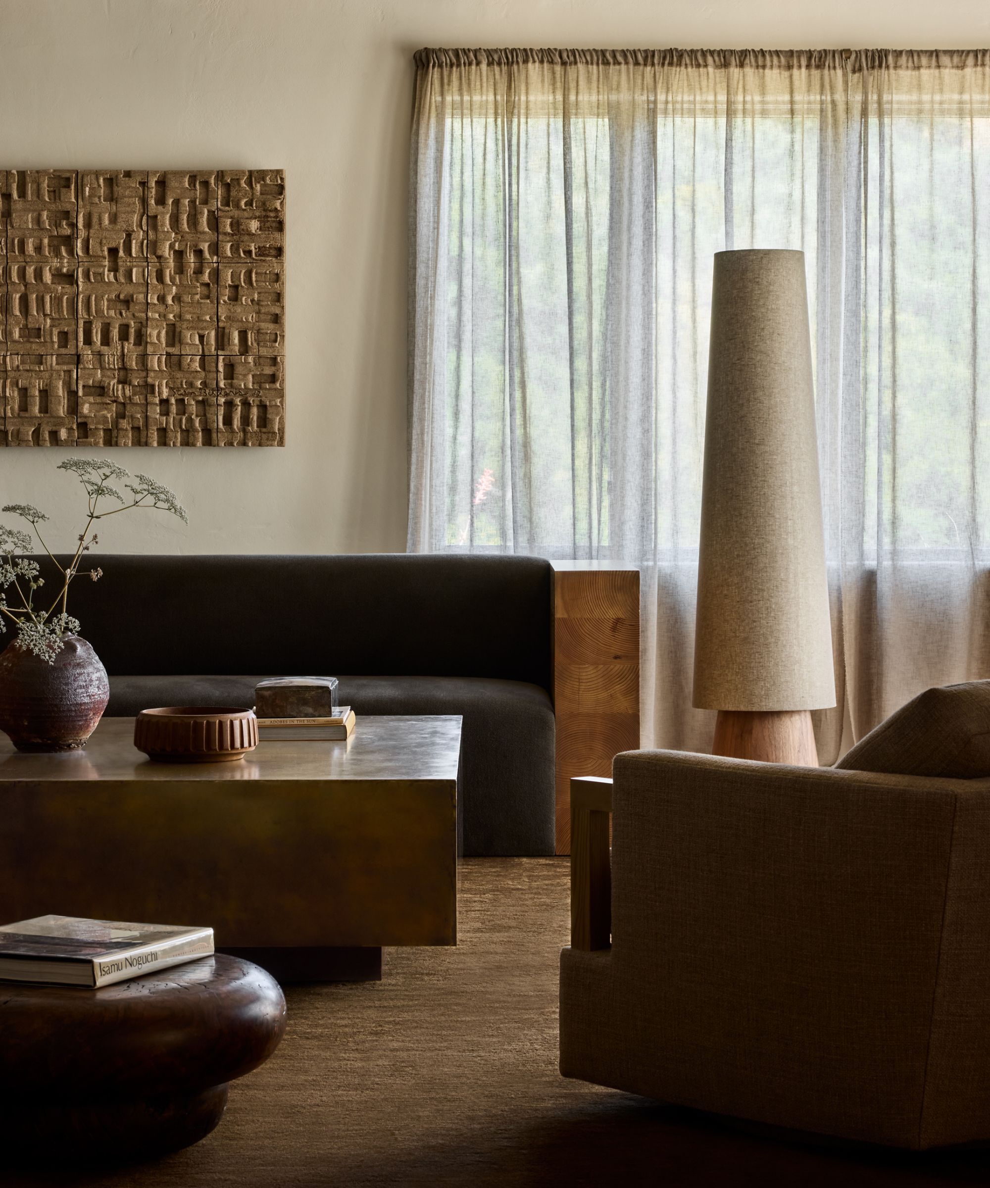 An adobe home living room with wooden furniture and organic colors