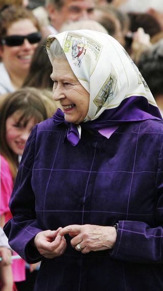 Queen Elizabeth II talks to wellwishers as she arrives to embark on the Hebridean Princess at Port Ellen for a week-long cruise around the Western Isles with her family to celebrate her 80th birthday on July 21, 2006 in the Isle of Islay, England.