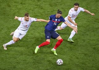 France midfielder Adrien Rabiot battles for the ball with Switzerland’s Silvan Widmer and Xherdan Shaqiri